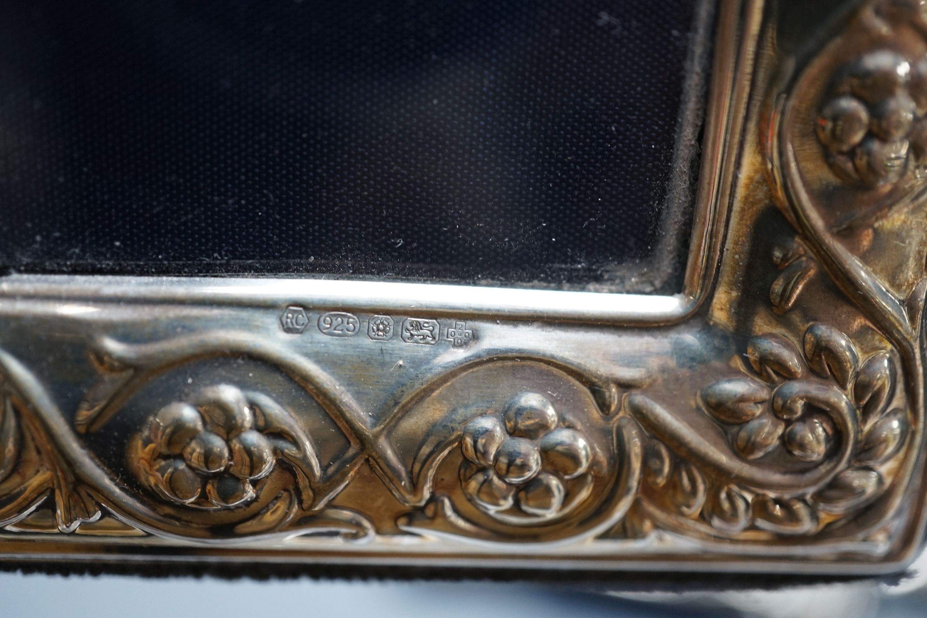 Two modern graduated pairs of decorated silver mounted photograph frames, Carrs of Sheffield, 2000 & 2001, largest 25.6cm and two smaller silver mounted frames.